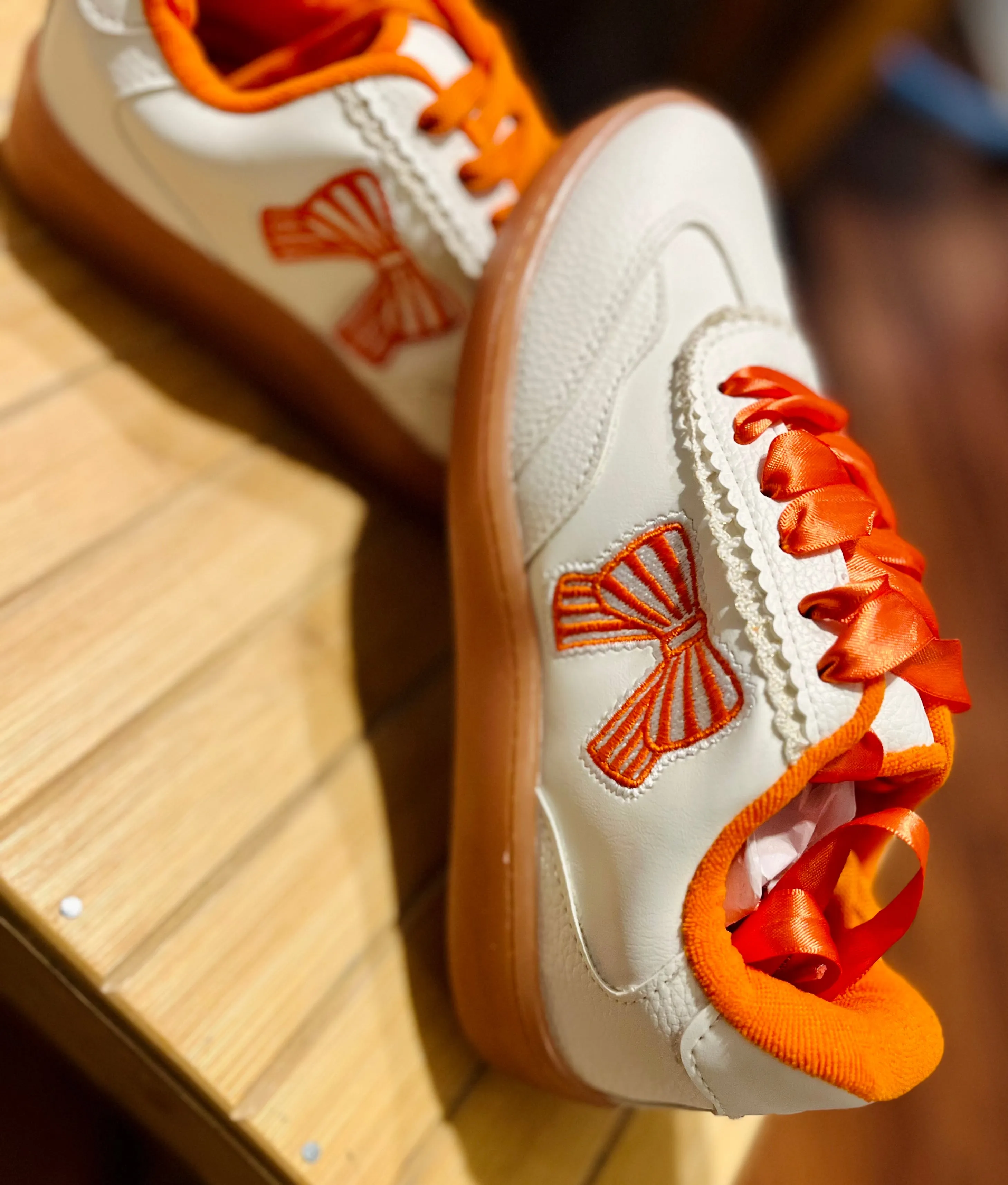 Orange bow sneakers