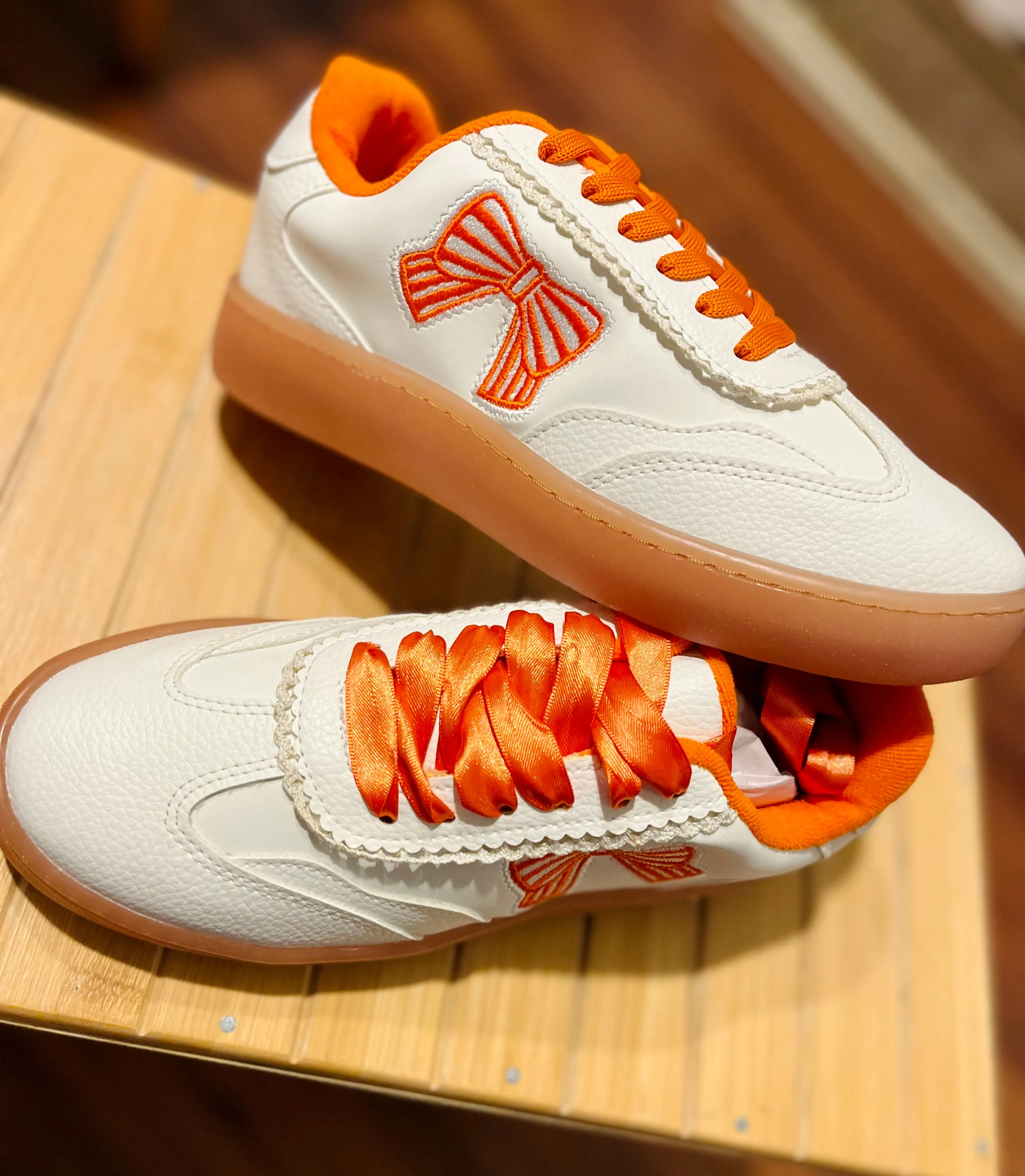 Orange bow sneakers